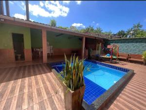 a house with a swimming pool on a wooden deck at COP30 na Araújo 385 in Ananindeua