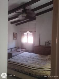 a bedroom with a bed and a ceiling fan at Irupé in Villa Carlos Paz