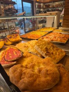 a display case with many different types of pies at B&B Massari in Preturo