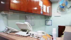 a hospital room with a dental machine on a counter at City Guest House in Hong Kong