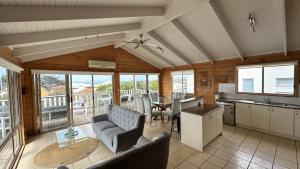 a kitchen and living room with a table and chairs at Dolphin in Apollo Bay