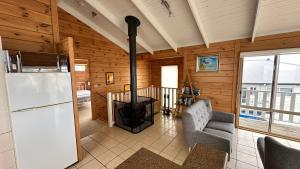 a living room with a refrigerator and a stove at Dolphin in Apollo Bay