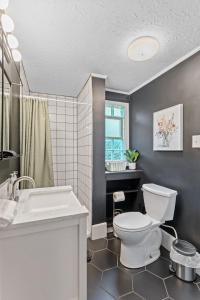 a bathroom with a white toilet and a sink at OrangeHome in Indianapolis +25 photos