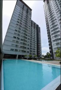 a large apartment building with a large swimming pool at Davao Condo - Avida Towers CM Recto in Davao City