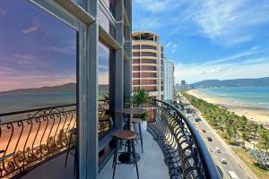 a balcony of a hotel with a view of the beach at Holiday Beach Hotel Danang in Da Nang