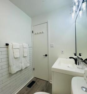 a white bathroom with a sink and a toilet at JDH Beachfront Retreat in Ocean City