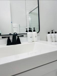 a bathroom counter with a mirror and a sink at JDH Beachfront Retreat in Ocean City +18 photos