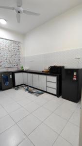 a kitchen with a counter and a refrigerator in a room at 88 Residence Homestay Musleem in Jitra +18 photos