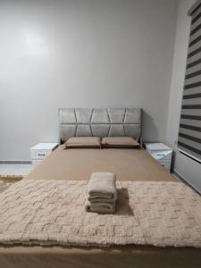 a bedroom with a bed with a blanket on it at 88 Residence Homestay Musleem in Jitra