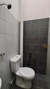 a small bathroom with a toilet and a shower at 88 Residence Homestay Musleem in Jitra