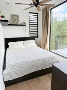 a bedroom with a bed and a window at La Casita de Acero in Rio Grande +18 photos