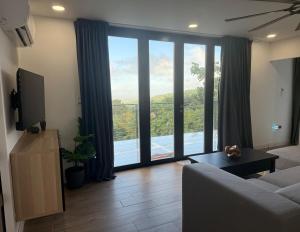 a living room with a couch and a large window at La Casita de Acero in Rio Grande