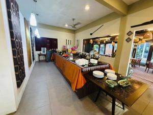 a kitchen with a long counter in a room at Tropical Langkawi in Pantai Cenang