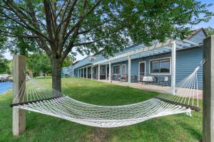 a hammock on the lawn in front of a house at Rustic 4-Lodge Stay - Perfect for Groups in Fife Lake +111 photos