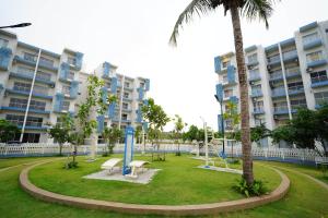 a park in front of a large apartment building at Lavender Villa Negombo Stylish Airport Retreat in Negombo
