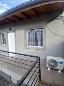 a balcony of a house with a window and a fan at Departamento castillo in Pilar