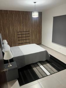 a bedroom with a bed and a projection screen at In Zire, a beautiful, fully-equipped rest house in Cedro