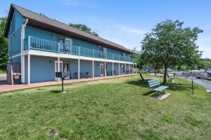a blue building with a bench in front of it at Group Stay - 3 Lodges Together by Fife Lake in Fife Lake