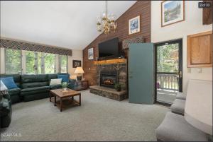 a living room with a couch and a fireplace at Quaint townhome in downtown Winter Park, Ski and Bikers Paradise, Walk to Town in Winter Park