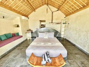 a bedroom with a large bed in a room at Penida View Village - Infinity pool & Volcano View in Nusa Penida +47 photos
