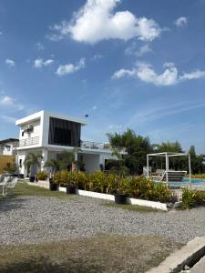 a white building with plants in front of it at Affordable Room in Angeles
