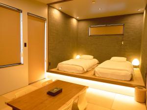 a bedroom with a mirror with two beds in it at FOG villa&spa in Kirishima