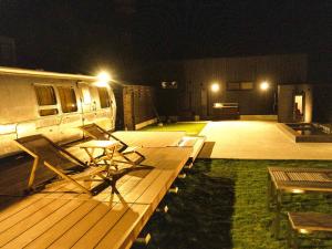 an rv parked on a deck at night at FOG villa&spa in Kirishima