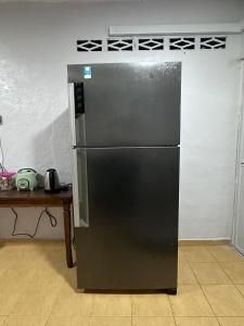 a black refrigerator in a kitchen next to a table at MAMAB SMART HOME STUDIO HOMESTAY - Tepi Highway Melor in Kota Bharu +13 photos