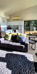 a living room with a couch and a table at Tamar Tonic - Lush River Views in Grindelwald