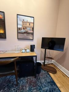 a room with a desk with a flat screen tv at Royal Oak Hotel in Ballarat