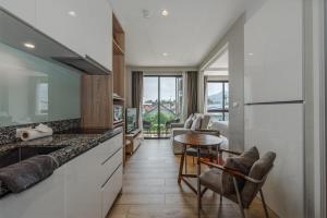 a kitchen with a counter and a table and chairs at Diamond Resort Phuket walk to Bangtao Beach in Phuket