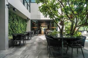 a patio with tables and chairs in a building at Diamond Resort Phuket walk to Bangtao Beach in Phuket