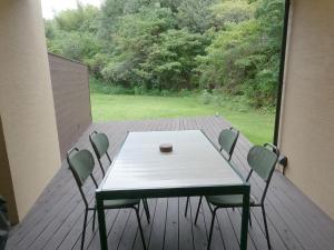 a table and chairs on a deck with a view at 伊勢志摩パールヴィレッジ ヴィラ in Shima +22 photos