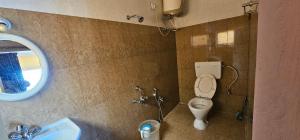 ein Badezimmer mit Toilette und Waschbecken in der Unterkunft Stay Awhile Cottages in Udagamandalam + 24 Fotos
