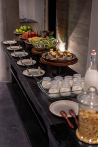 a buffet line with plates and bowls of food at Hôtel de Soie in Danang