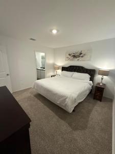 a bedroom with a large white bed and two lamps at Modern 3BR 2BA Home - Family-Friendly Spring, TX in Spring +40 photos
