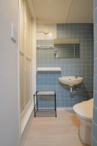 a bathroom with blue tiles and a sink at Encounter Ohashi in Fukuoka +35 photos