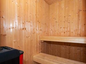 a sauna with wooden walls and a wooden shelf at 4 star holiday home in Ringkøbing in Ringkøbing