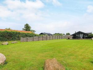 a yard with a fence and a house at 5 person holiday home in Otterup in Otterup