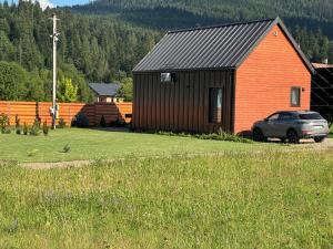 a house with a car parked in front of it at Barn S&S House in Mykulychyn