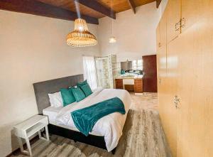 a bedroom with a large bed with green pillows at Spacious 4Br Home In Bo Kaap With Mountain And Ocean View 5 min From Cape Town CBD in Cape Town