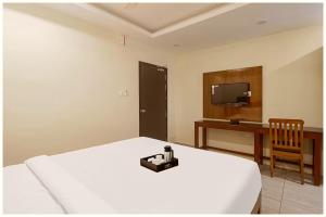 a bedroom with a bed and a desk and a television at Hotel Imperial Nayna Near the mall road - Naini Lake - Best Budget Hotel in Nainital