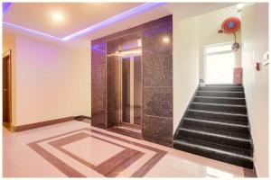a staircase in a building with black tiles at Hotel Imperial Nayna Near the mall road - Naini Lake - Best Budget Hotel in Nainital