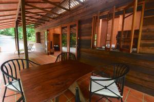 a wooden table and chairs on a porch at Daintree Cascades in Cape Tribulation +28 photos