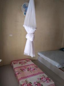 a bedroom with two beds and a bedsheet at Jhony's Backpacker-Guest House only stay here book treking with us in Bukit Lawang