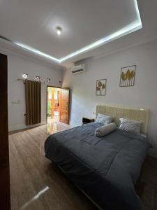 a bedroom with a large bed in a room at Homestay Joglo Beji in Gading
