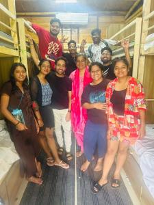 a group of people posing for a picture in a hospital bed at Jeet hostel and Stay Rooms in Palolem