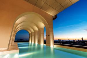 a swimming pool on the roof of a building with a view at Arjuna Solitaire Hotel in Sihanoukville
