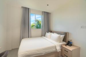 a hotel room with a bed and a window at Nest by Hawks Hotels Kamadhoo Baa Atoll in Kamadhoo