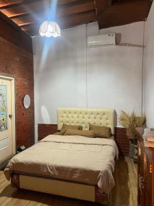 a bedroom with a bed in a room at Homestay Omah Joglo in Gading